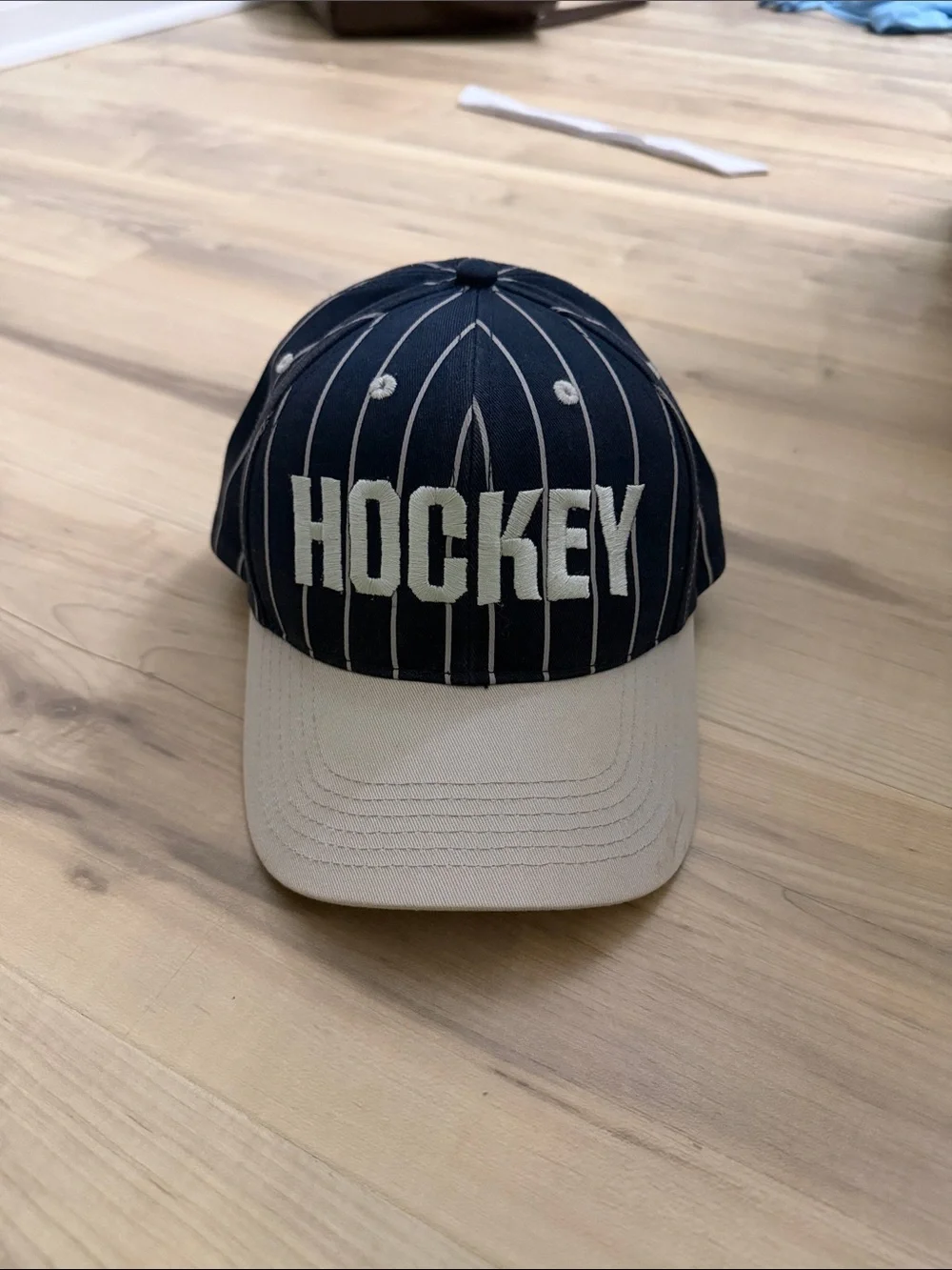Hockey eyes without a face white and navy striped hat